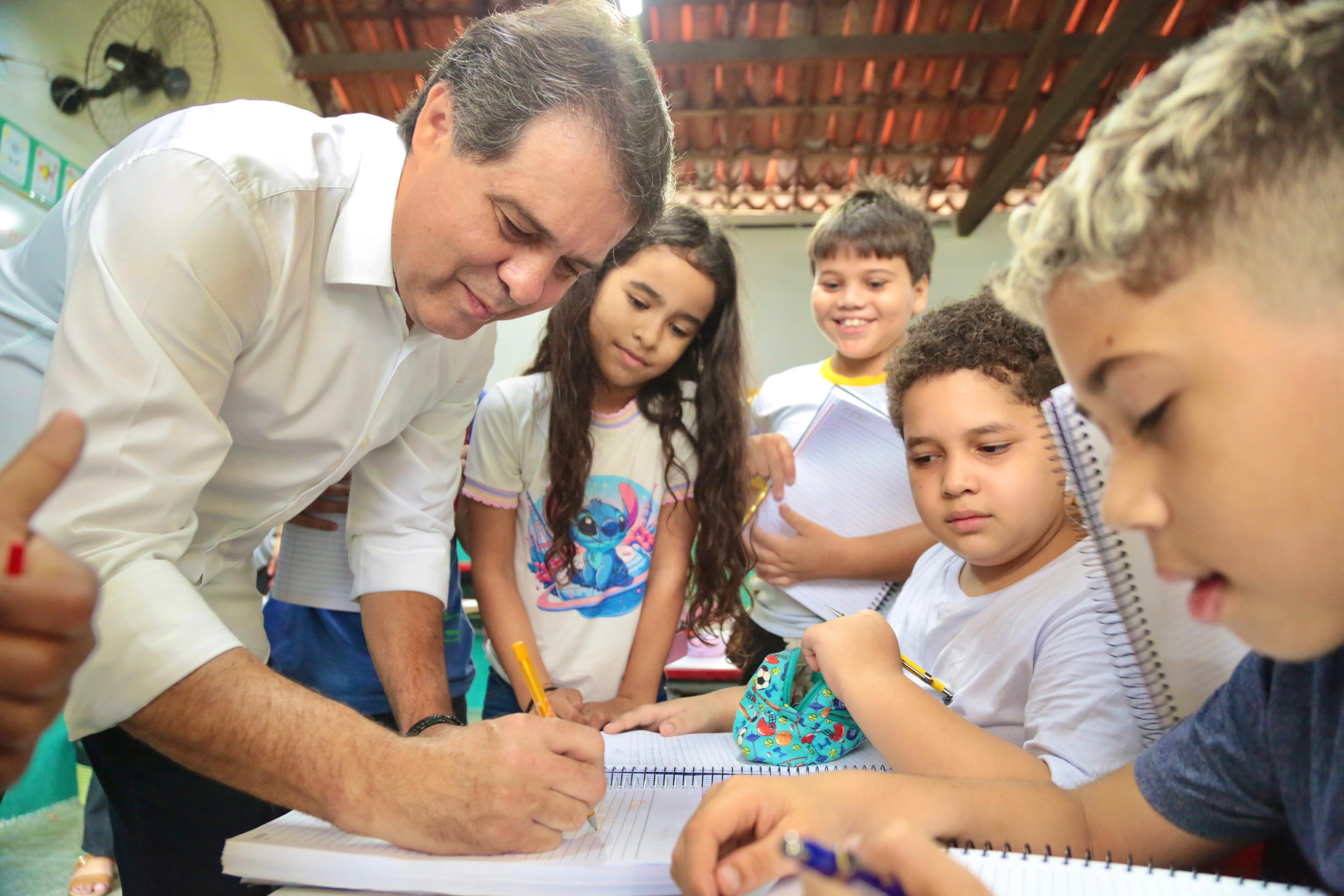 prefeito evandro conversa com alunos em uma sala de aula